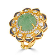 Gold ring with a green gemstone and diamond-like stones on a white background